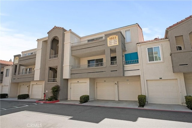 1023 Vista Del Cerro Dr Unit 205, Corona, CA 92879 - view of property with a garage