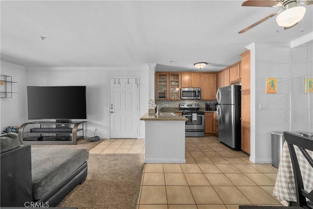 1023 Vista Del Cerro Dr Unit 205, Corona, CA 92879 - kitchen featuring stainless steel appliances, open floor plan, light tile patterned flooring, a ceiling fan, and glass insert cabinets