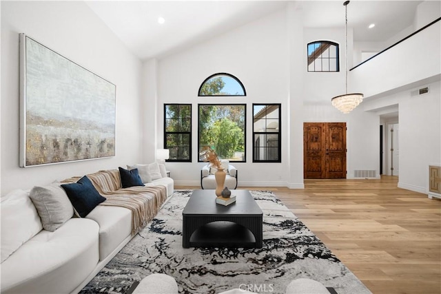 22011 La Puente Rd, Walnut, CA 91789 - living room with light wood-style floors, healthy amount of natural light, high vaulted ceiling, baseboards, and recessed lighting