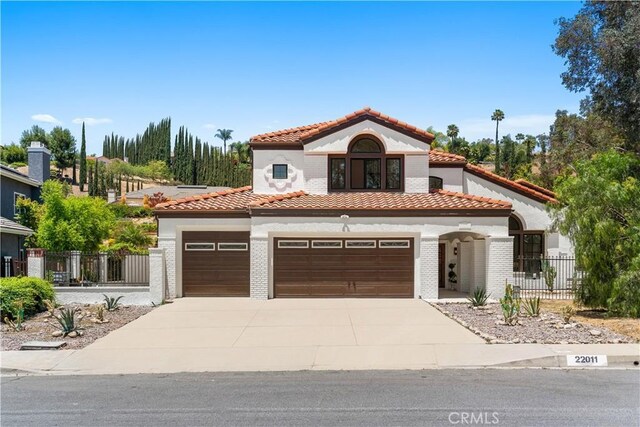 22011 La Puente Rd, Walnut, CA 91789 - mediterranean / spanish-style home with a tiled roof, driveway, stucco siding, and a garage
