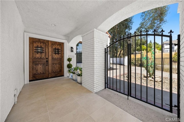 22011 La Puente Rd, Walnut, CA 91789 - doorway to property with a gate, stucco siding, and brick siding