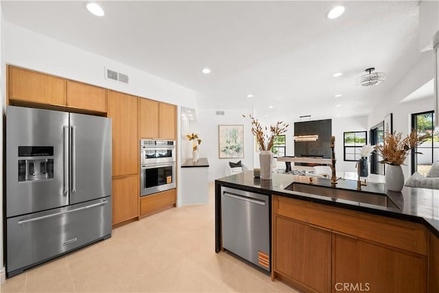 22011 La Puente Rd, Walnut, CA 91789 - kitchen featuring appliances with stainless steel finishes, recessed lighting, brown cabinetry, open floor plan, and a sink