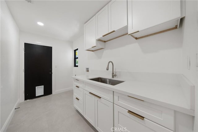 22011 La Puente Rd, Walnut, CA 91789 - kitchen featuring a sink, baseboards, white cabinetry, light countertops, and recessed lighting