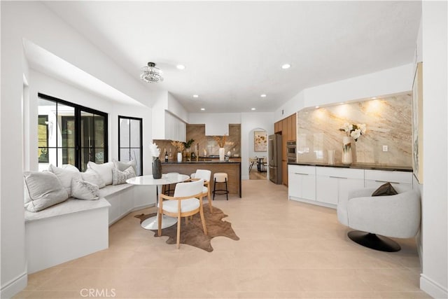 22011 La Puente Rd, Walnut, CA 91789 - living area featuring arched walkways, light tile patterned floors, and recessed lighting