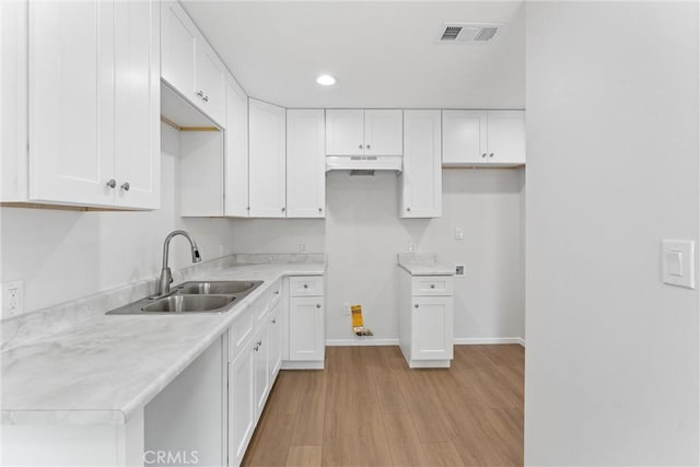 1121 S Dover Cir Unit C44K, Anaheim, CA 92805 - kitchen with a sink, under cabinet range hood, white cabinets, and recessed lighting