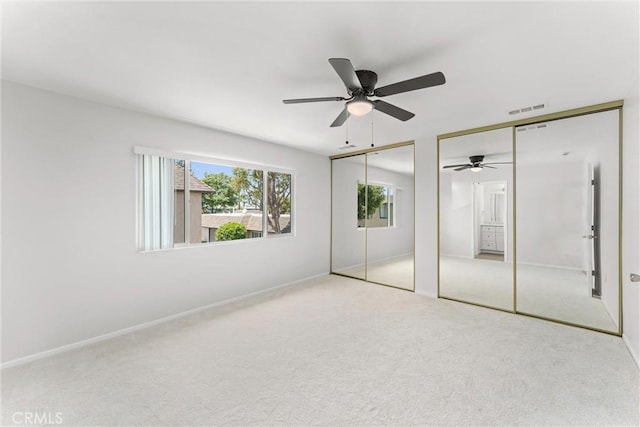 1121 S Dover Cir Unit C44K, Anaheim, CA 92805 - unfurnished bedroom featuring multiple closets, carpet floors, baseboards, and a ceiling fan