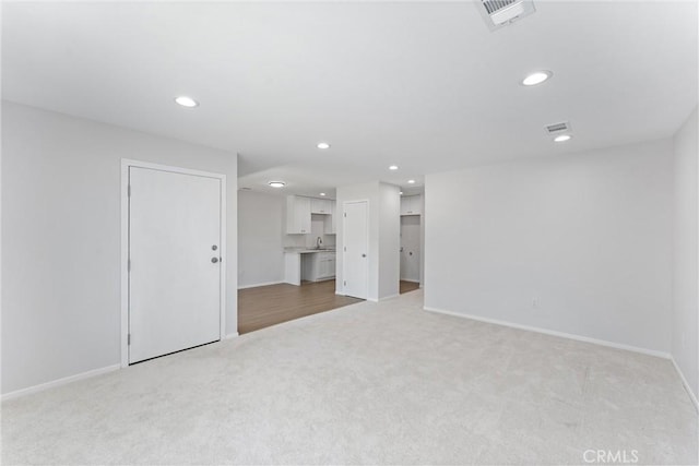 1121 S Dover Cir Unit C44K, Anaheim, CA 92805 - below grade area with light carpet, recessed lighting, baseboards, and a sink