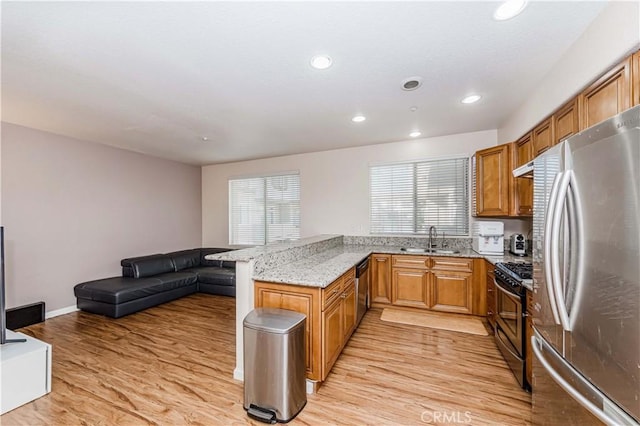 4536 Montecito Dr, La Palma, CA 90623 - kitchen with stainless steel appliances, a sink, a peninsula, light wood finished floors, and recessed lighting