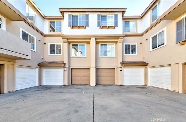 4536 Montecito Dr, La Palma, CA 90623 - rear view of property featuring stucco siding, a garage, and driveway
