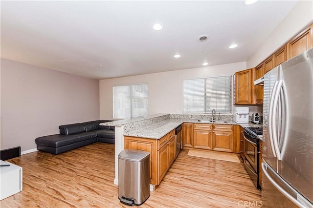 4536 Montecito Dr, La Palma, CA 90623 - kitchen featuring stainless steel appliances, a sink, light wood-type flooring, a peninsula, and recessed lighting