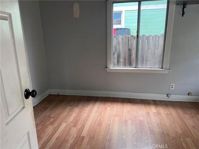 1903 E 59th St, Long Beach, CA 90805 - unfurnished room with wood finished floors and baseboards