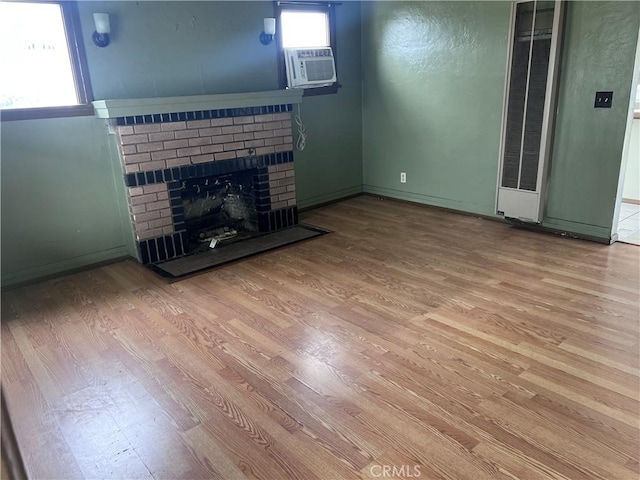 1903 E 59th St, Long Beach, CA 90805 - unfurnished living room with wood finished floors, a heating unit, cooling unit, a fireplace, and baseboards