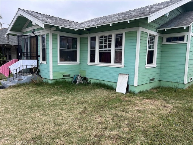 1909 E 59th St, Long Beach, CA 90805 - view of side of property featuring crawl space and a lawn