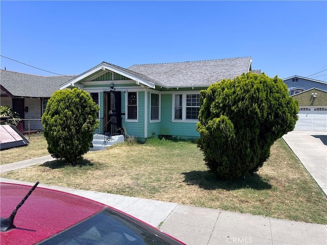 1909 E 59th St, Long Beach, CA 90805 - view of front of property featuring a front lawn and a shingled roof