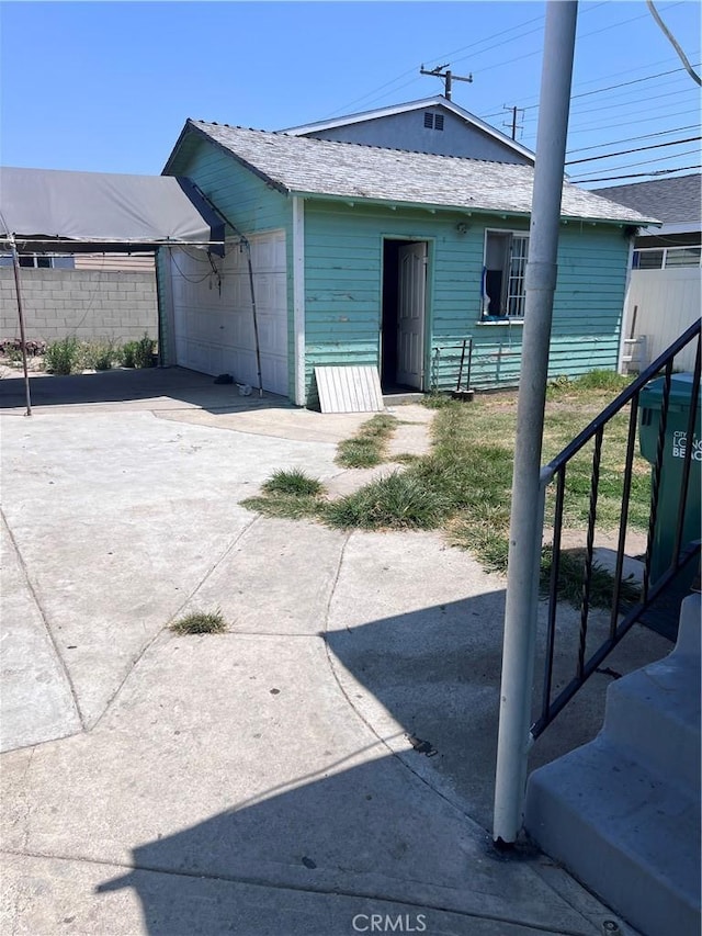 1909 E 59th St, Long Beach, CA 90805 - back of property with a detached garage and stairs