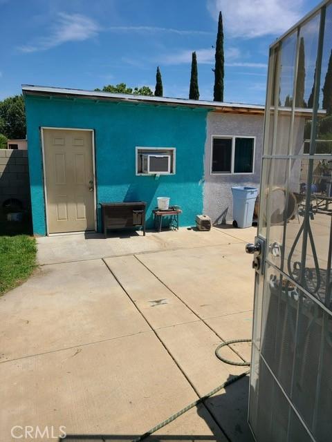 14680 Upland Ave, Fontana, CA 92335 - rear view of house with stucco siding and a patio