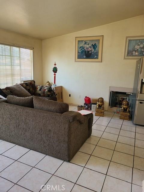 14680 Upland Ave, Fontana, CA 92335 - living room with light tile patterned floors and lofted ceiling