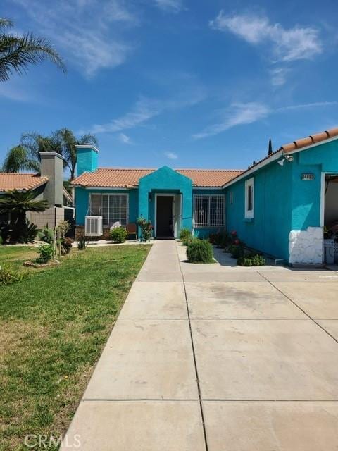 14680 Upland Ave, Fontana, CA 92335 - view of front of property featuring a front yard, a tiled roof, and stucco siding