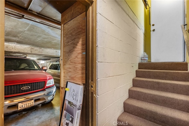 5463 Newcastle Ave Unit 8, Encino, CA 91316 - staircase featuring concrete floors and concrete block wall