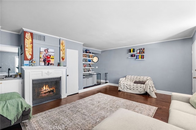 5463 Newcastle Ave Unit 8, Encino, CA 91316 - living area featuring crown molding, a warm lit fireplace, wood finished floors, and baseboards