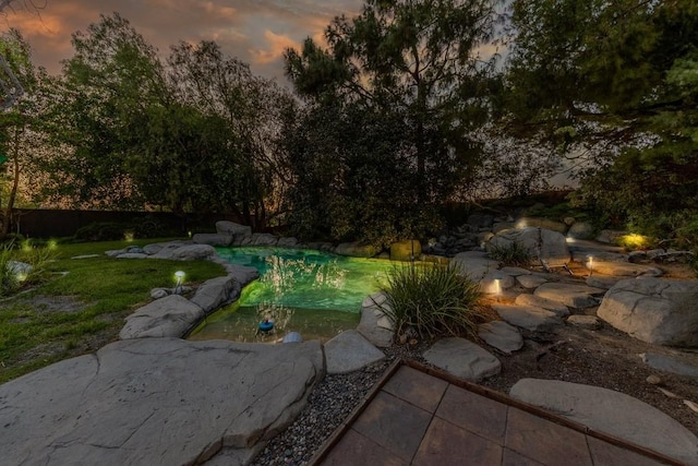 18269 Laurel View Dr, Yorba Linda, CA 92886 - pool at dusk featuring a yard, an outdoor pool, and a patio area