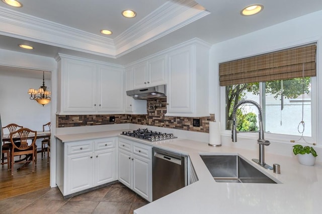18269 Laurel View Dr, Yorba Linda, CA 92886 - kitchen featuring appliances with stainless steel finishes, under cabinet range hood, white cabinets, backsplash, and crown molding