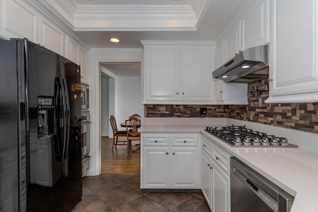 18269 Laurel View Dr, Yorba Linda, CA 92886 - kitchen with appliances with stainless steel finishes, under cabinet range hood, a raised ceiling, white cabinetry, and light countertops