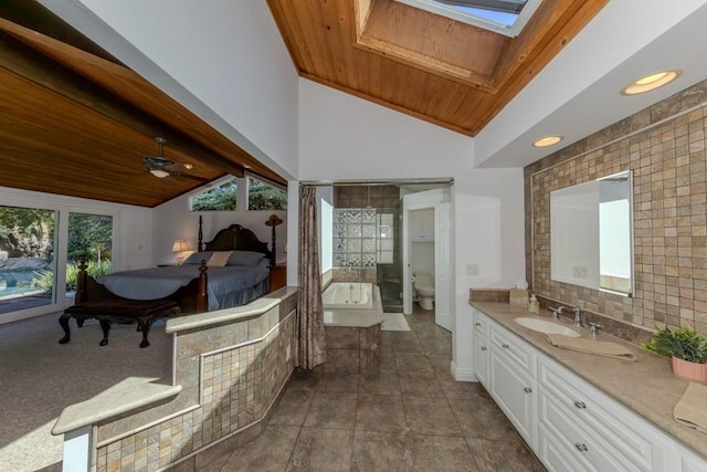 18269 Laurel View Dr, Yorba Linda, CA 92886 - bathroom with wooden ceiling, vanity, a skylight, a relaxing tiled tub, and backsplash