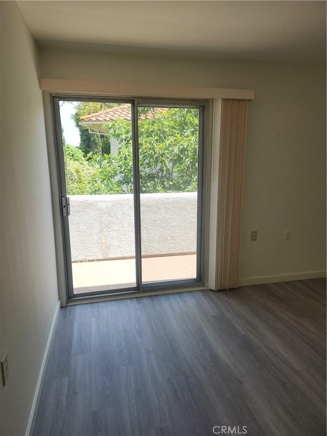 2119 Via Puerta Unit Q, Laguna Woods, CA 92637 - unfurnished room with healthy amount of natural light, baseboards, and wood finished floors