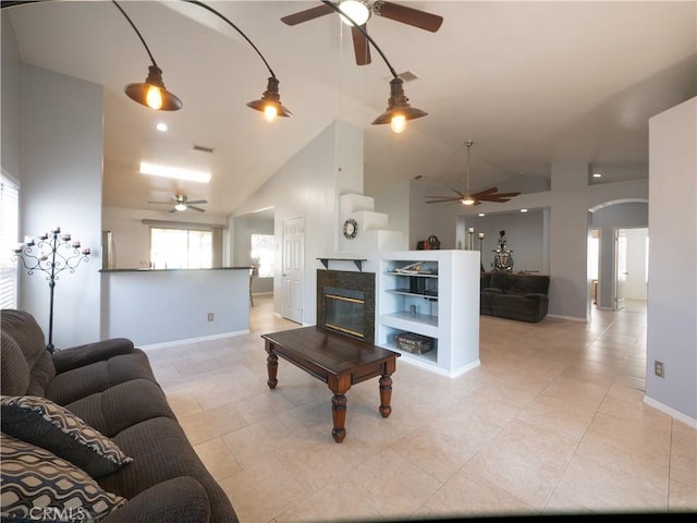1173 Conestoga St, Corona, CA 92881 - living area featuring ceiling fan, arched walkways, baseboards, and high vaulted ceiling