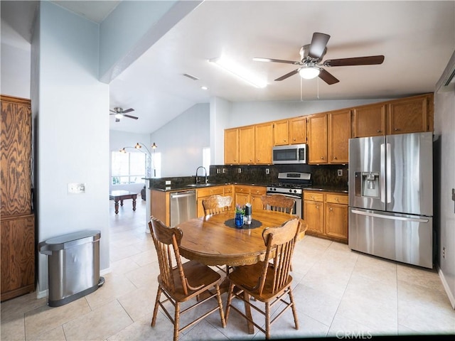 1173 Conestoga St, Corona, CA 92881 - kitchen featuring stainless steel appliances, vaulted ceiling, a ceiling fan, and dark countertops