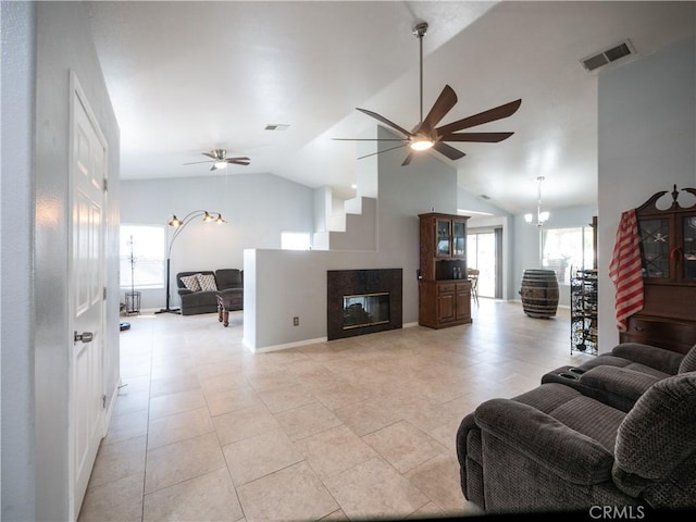 1173 Conestoga St, Corona, CA 92881 - living room featuring a ceiling fan, vaulted ceiling, light tile patterned floors, and a multi sided fireplace