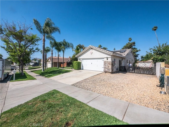 1173 Conestoga St, Corona, CA 92881 - single story home with stucco siding, roof mounted solar panels, driveway, an attached garage, and a gate