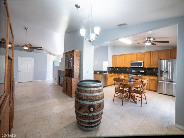 1173 Conestoga St, Corona, CA 92881 - kitchen with appliances with stainless steel finishes, ceiling fan, dark countertops, backsplash, and high vaulted ceiling