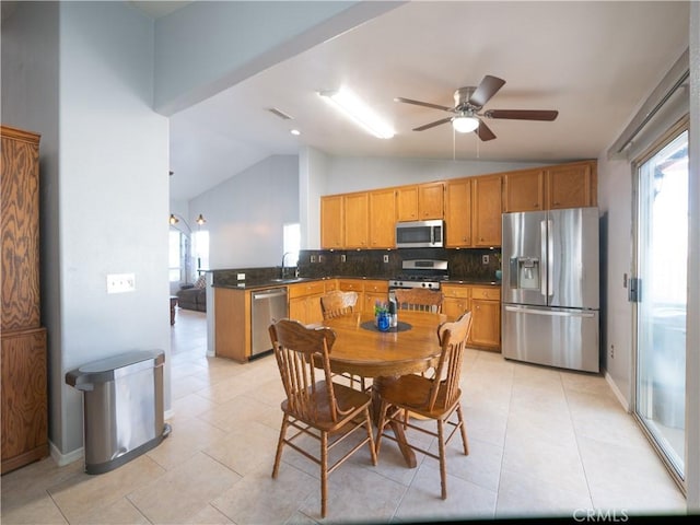 1173 Conestoga St, Corona, CA 92881 - kitchen with appliances with stainless steel finishes, lofted ceiling, dark countertops, backsplash, and a ceiling fan