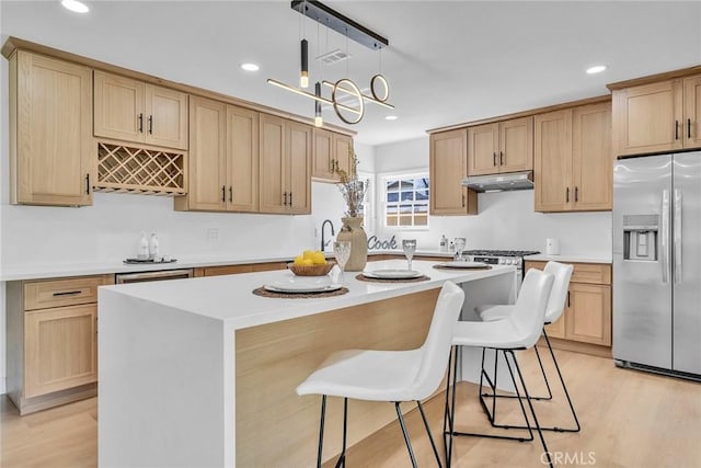 1321 S 8th Ave, Arcadia, CA 91006 - kitchen with stainless steel refrigerator with ice dispenser, a kitchen island, light wood-style flooring, light countertops, and under cabinet range hood