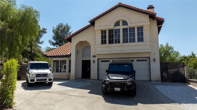 20128 Cavern Ct, Saugus, CA 91390 - mediterranean / spanish home with driveway, a garage, stucco siding, and a chimney