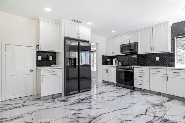 20128 Cavern Ct, Saugus, CA 91390 - kitchen featuring appliances with stainless steel finishes, light marble finish flooring, tasteful backsplash, white cabinetry, and recessed lighting