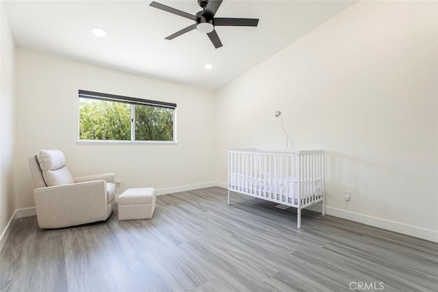 20128 Cavern Ct, Saugus, CA 91390 - bedroom with baseboards, wood finished floors, a crib, and recessed lighting