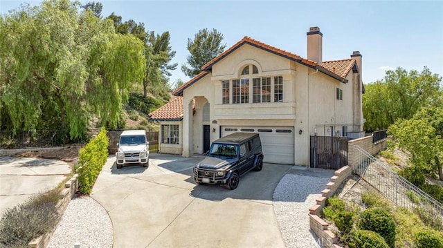 20128 Cavern Ct, Saugus, CA 91390 - rear view of property featuring a chimney, concrete driveway, a tile roof, a garage, and stucco siding
