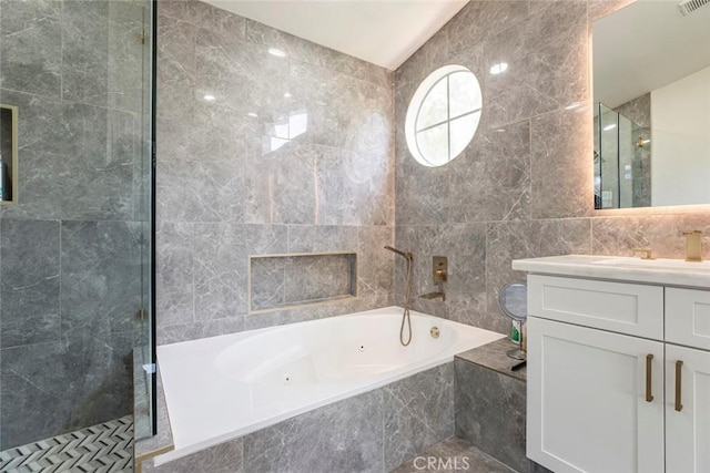 20128 Cavern Ct, Saugus, CA 91390 - bathroom featuring tile walls, tiled shower, a tub with jets, and vanity