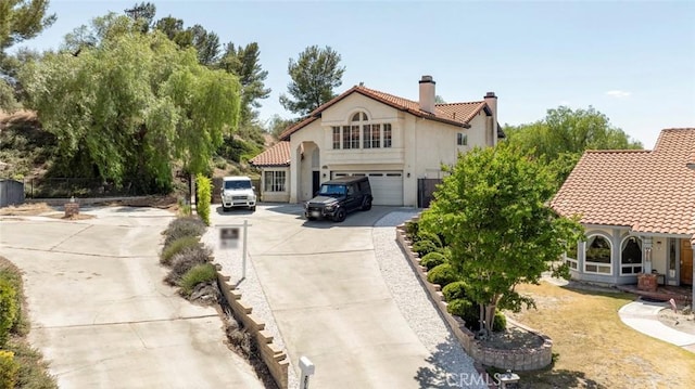 20128 Cavern Ct, Saugus, CA 91390 - mediterranean / spanish home with driveway, a tiled roof, a chimney, an attached garage, and stucco siding