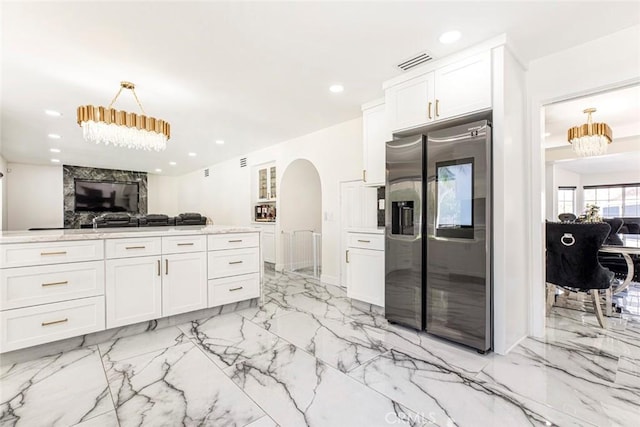 20128 Cavern Ct, Saugus, CA 91390 - kitchen featuring stainless steel fridge with ice dispenser, open floor plan, arched walkways, white cabinetry, and recessed lighting