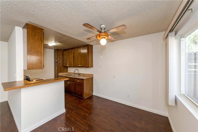 2408 S Hacienda Blvd Unit K2, Hacienda Heights, CA 91745 - kitchen with ceiling fan, a textured ceiling, a sink, baseboards, and a peninsula