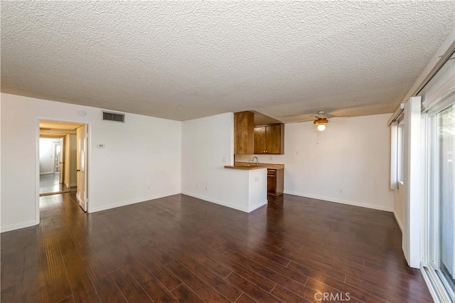 2408 S Hacienda Blvd Unit K2, Hacienda Heights, CA 91745 - unfurnished living room featuring a ceiling fan, a textured ceiling, dark wood finished floors, and baseboards