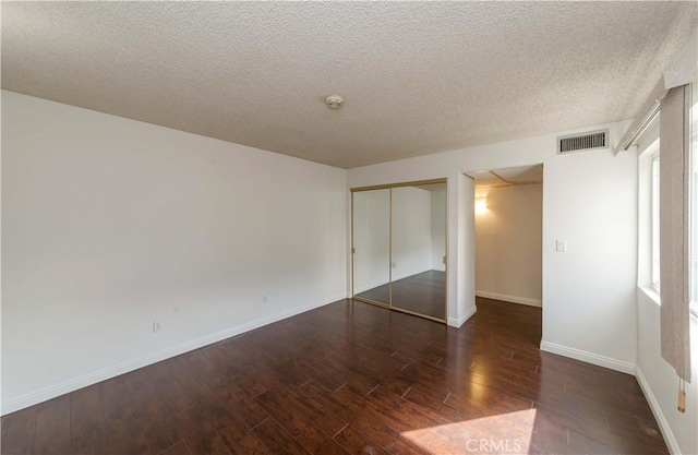 2408 S Hacienda Blvd Unit K2, Hacienda Heights, CA 91745 - unfurnished bedroom featuring wood finished floors, a closet, baseboards, and a textured ceiling