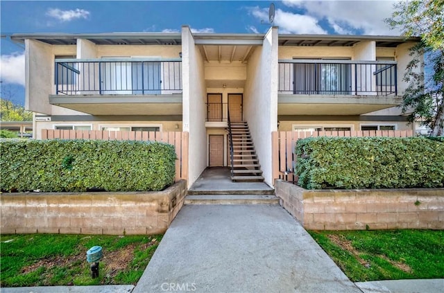 2408 S Hacienda Blvd Unit K2, Hacienda Heights, CA 91745 - view of front facade featuring a balcony, stairway, and stucco siding