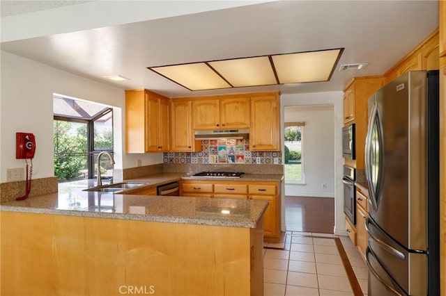3016 Daphney Ct, Simi Valley, CA 93063 - kitchen with stainless steel appliances, healthy amount of natural light, under cabinet range hood, and light tile patterned floors