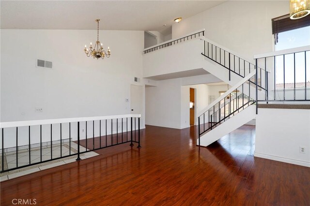 3016 Daphney Ct, Simi Valley, CA 93063 - spare room featuring high vaulted ceiling, a chandelier, wood finished floors, and stairs
