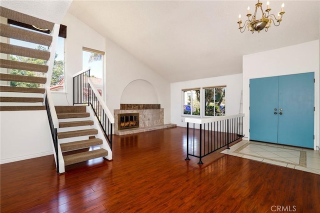 3016 Daphney Ct, Simi Valley, CA 93063 - entryway with stairs, wood finished floors, a chandelier, a tiled fireplace, and high vaulted ceiling